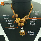 A display of various Rudraksha beads including 3 Mukhi, 4 Mukhi, 5 Mukhi, 6 Mukhi, 7 Mukhi, Ganesha, and Gauri Shankar types, arranged on a mannequin torso to showcase their relative sizes and shapes.